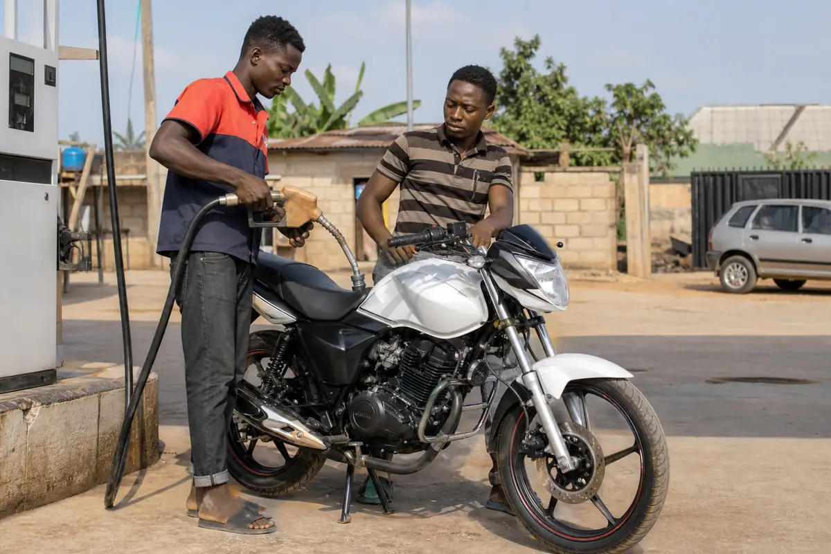 A motorcycle being refuelled at a roadside filling station