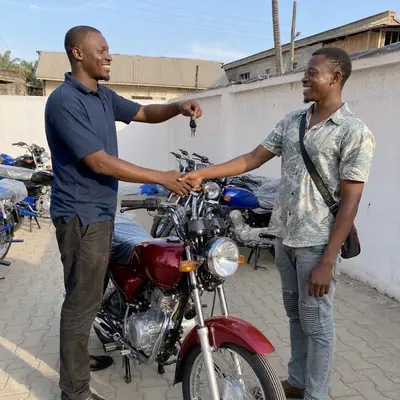 A customer receiving the keys of his new motorcycle